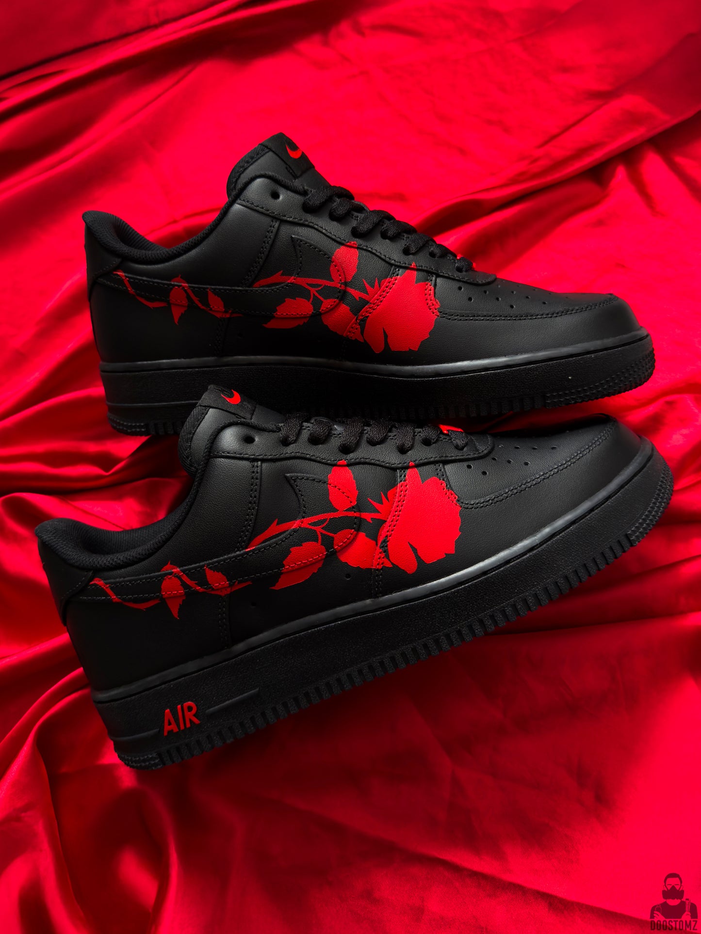 Pair of black Nike Air Force 1 custom shoes featuring red roses across both sides