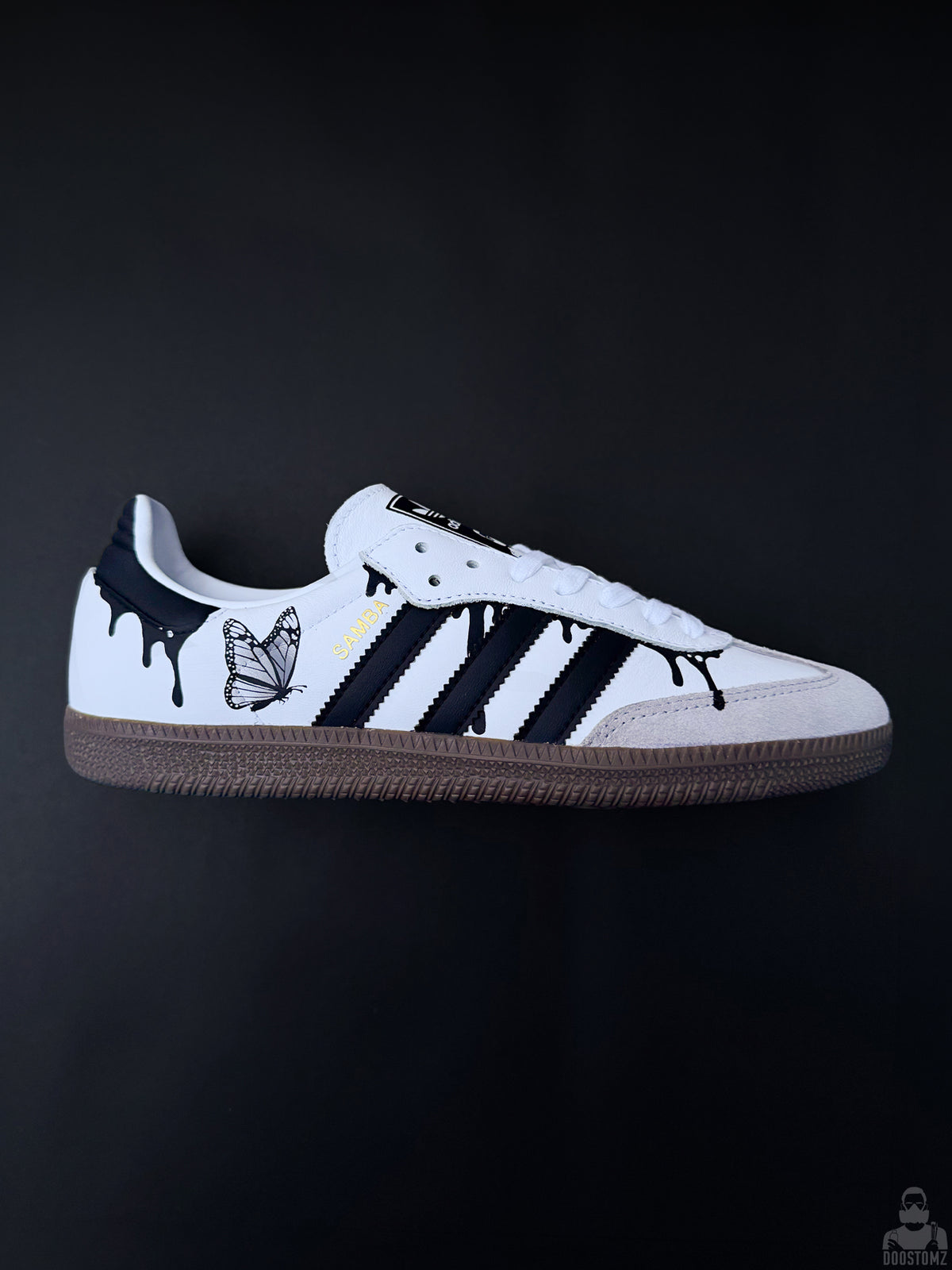 Custom Adidas Samba sneakers with black drip design and butterfly artwork on a black background
