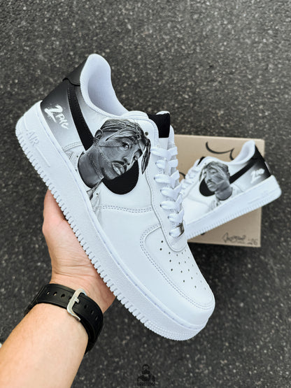 Custom Nike Air Force 1 Low sneakers featuring a black and white Tupac Shakur portrait hand painted on the side panel with monochrome details