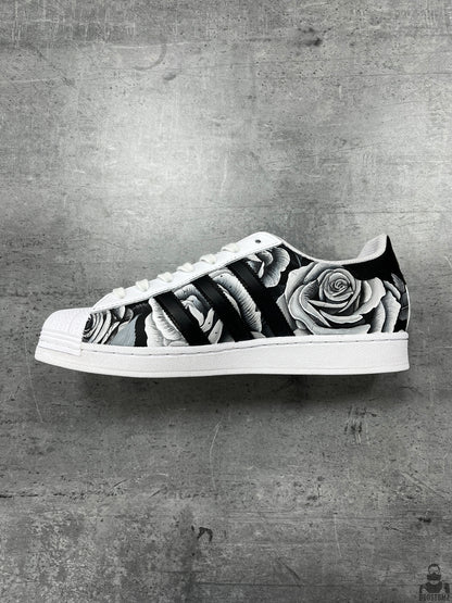 Side view of Adidas Superstar Black & White Roses Custom sneakers featuring detailed hand-painted roses and black stripes