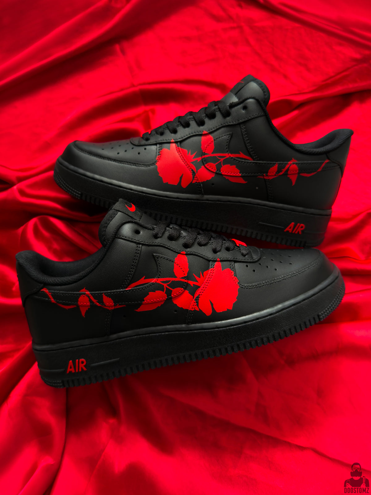 Black Nike Air Force 1 custom sneakers with hand-painted red roses on both shoes