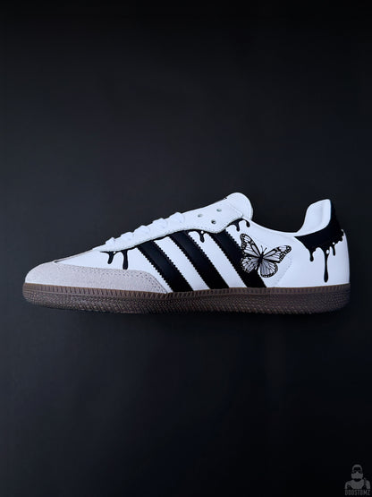 Custom Adidas Samba sneakers with black stripes, drip details and butterfly artwork, side view