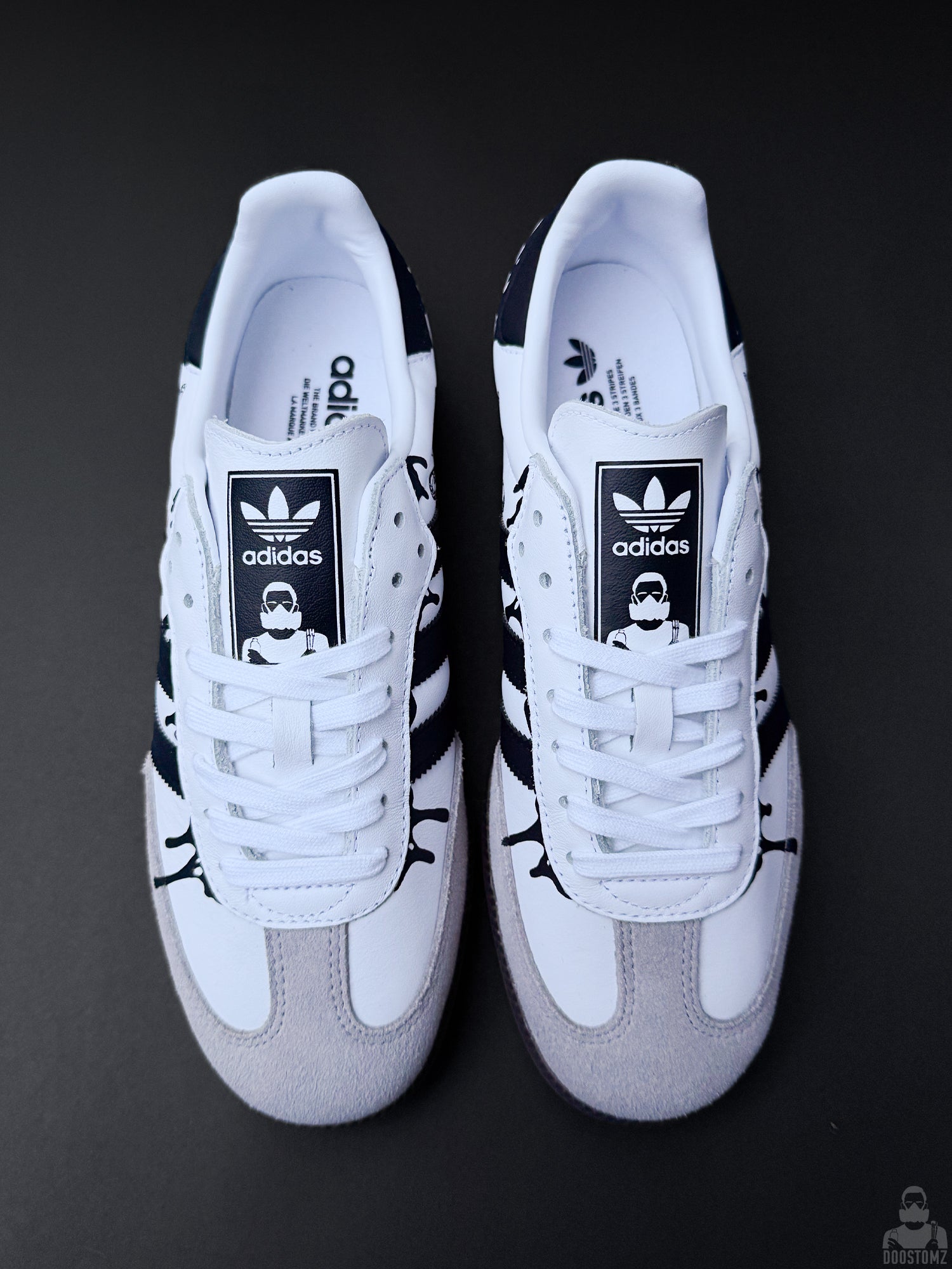 Custom Adidas Samba sneakers shown from above with black drip details and DOOSTOMZ tongue labels