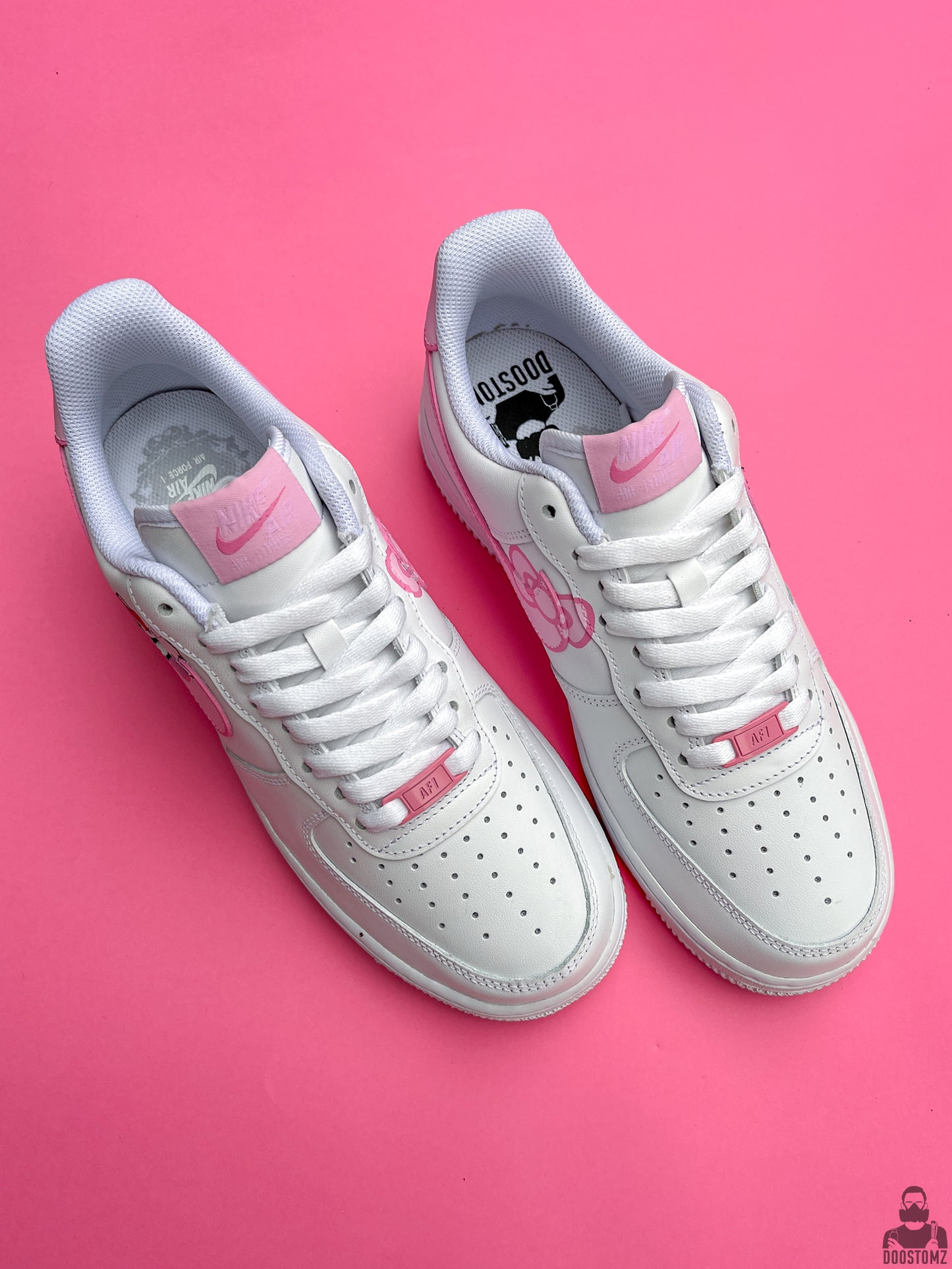 Top view of custom Nike Air Force 1 Hello Kitty sneakers with pink artwork, white laces and personalized details