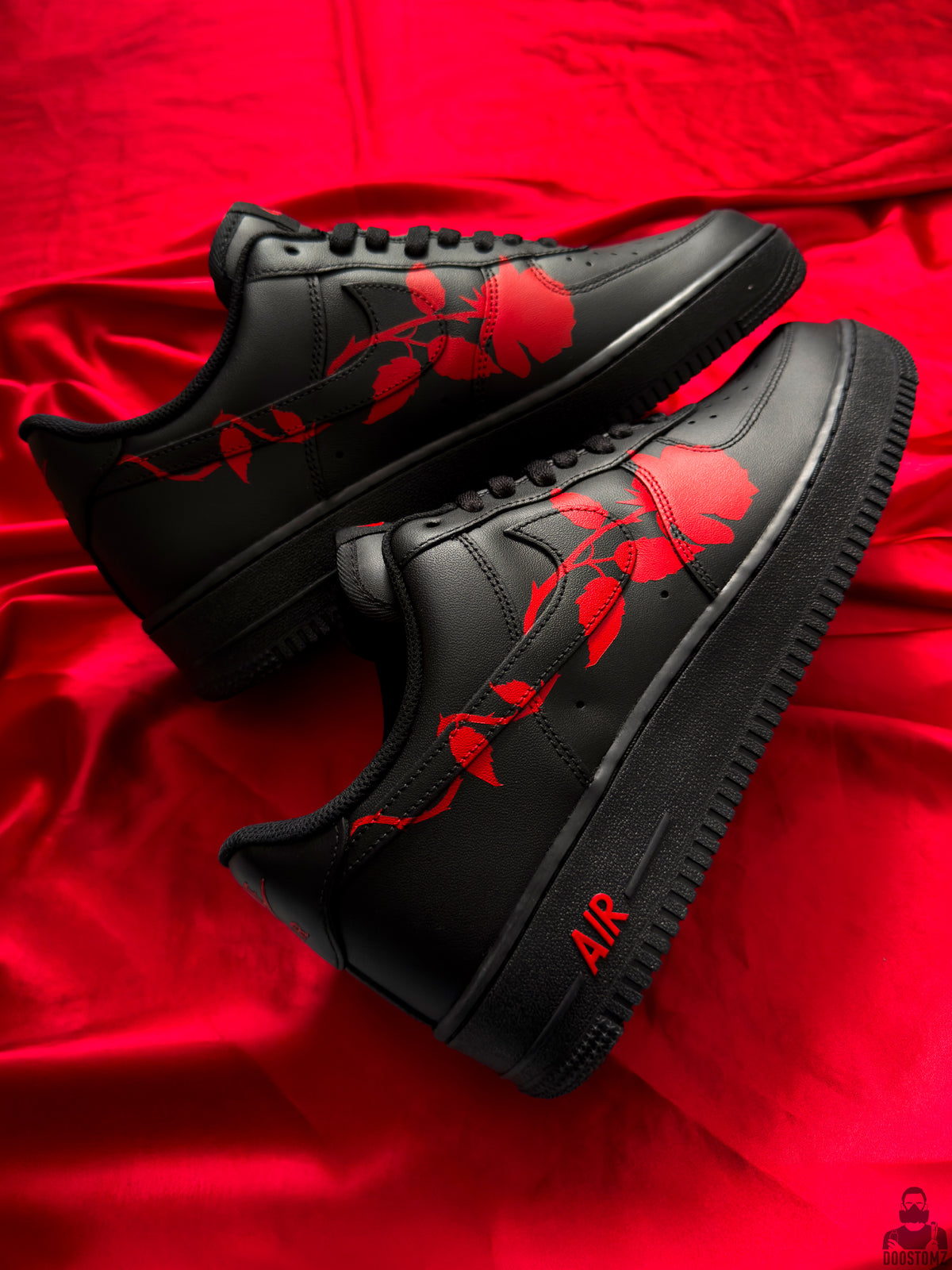 Black Nike Air Force 1 custom sneakers with continuous red rose artwork on both shoes