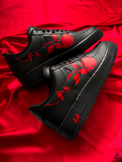 Black Nike Air Force 1 custom sneakers with continuous red rose artwork on both shoes