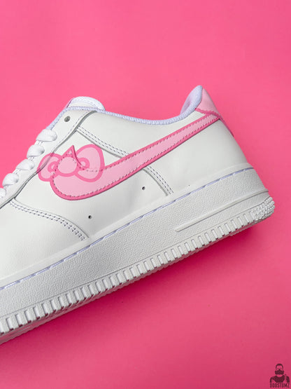 Close-up of Nike Air Force 1 Hello Kitty Custom sneakers showing hand-painted pink artwork and white leather details