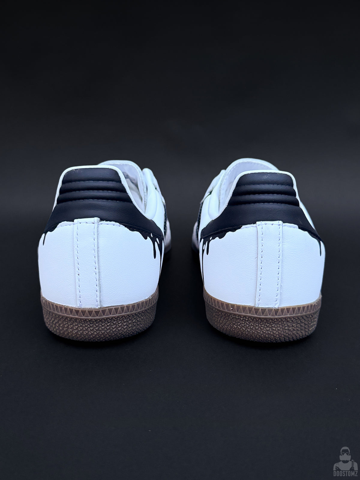 Rear view of custom Adidas Samba sneakers with black heel panels and dripping paint details