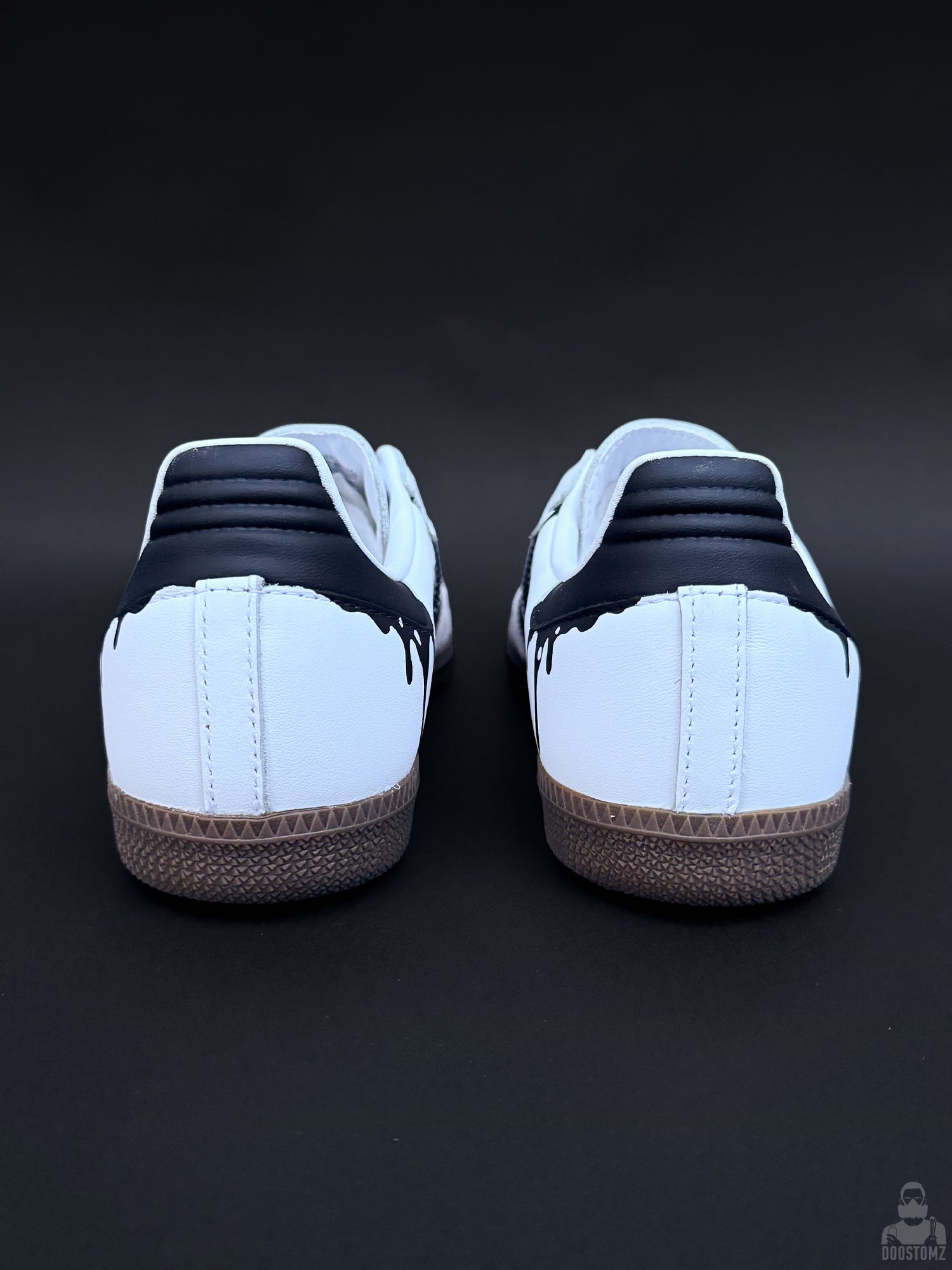 Rear view of custom Adidas Samba sneakers with black heel panels and dripping paint details