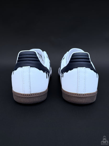 Rear view of custom Adidas Samba sneakers with black heel panels and dripping paint details