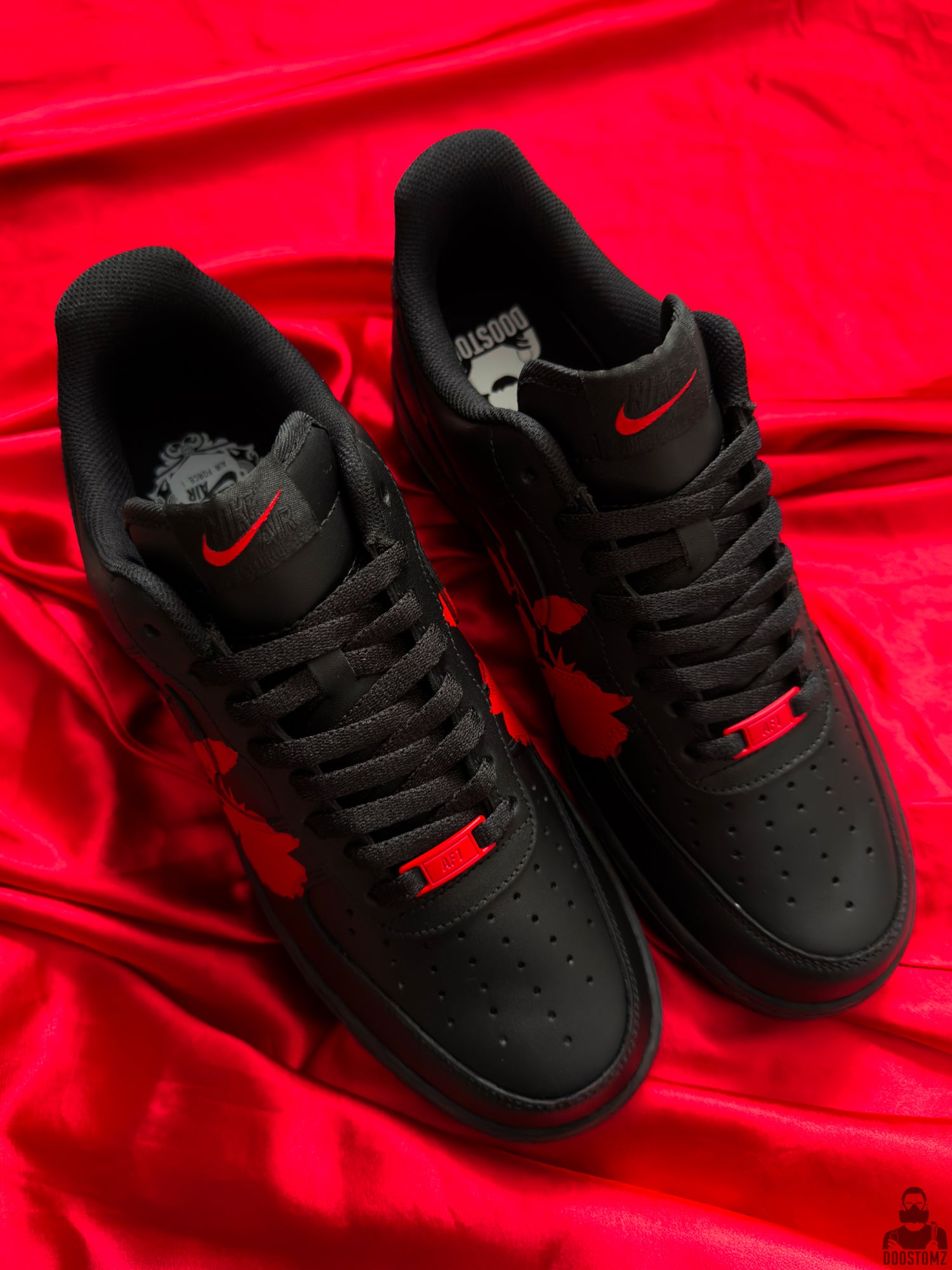 Black custom Nike Air Force 1 sneakers with red rose artwork viewed from above