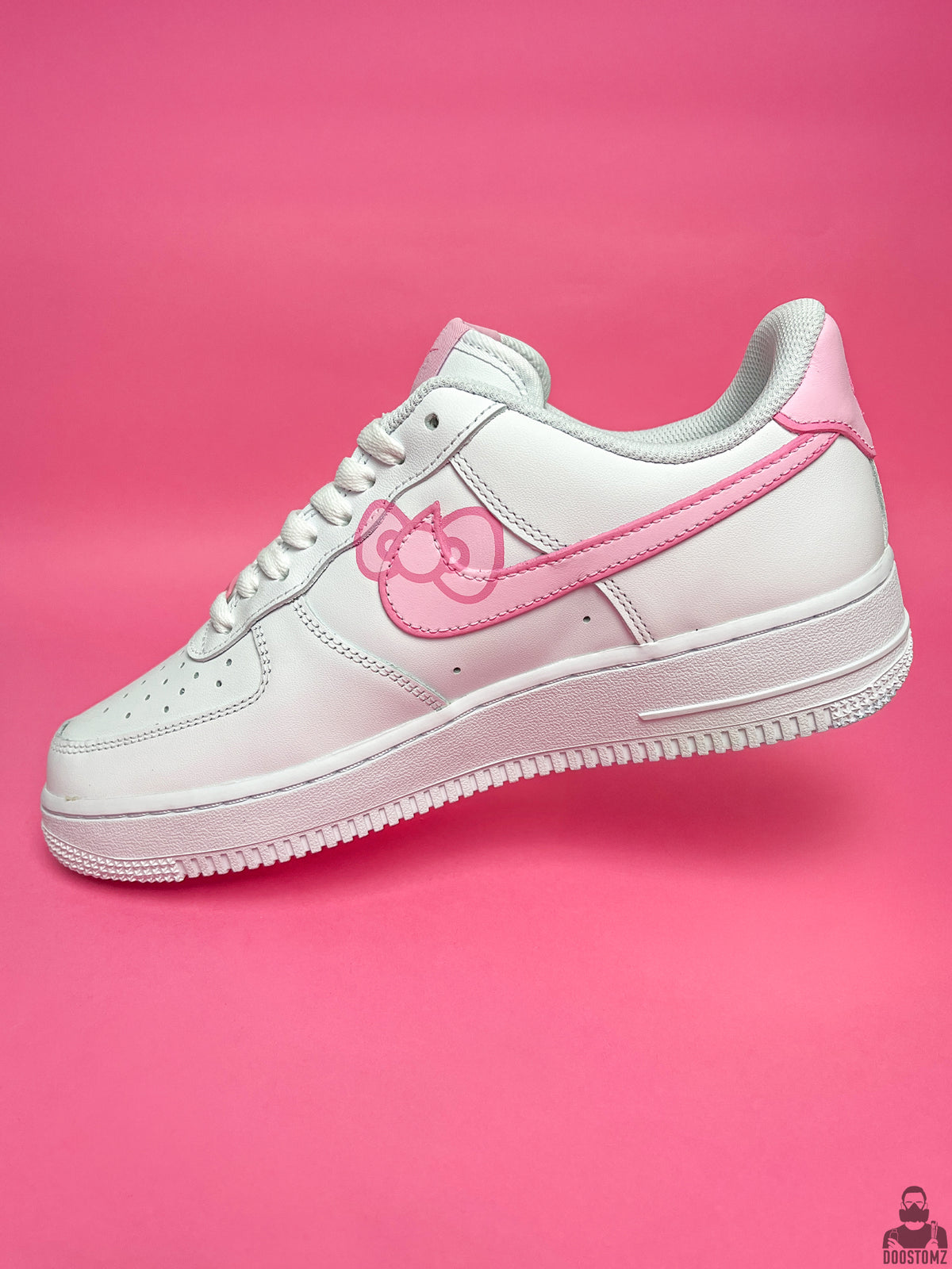 Nike Air Force 1 Hello Kitty Custom side profile featuring hand-painted pink artwork on a white sneaker