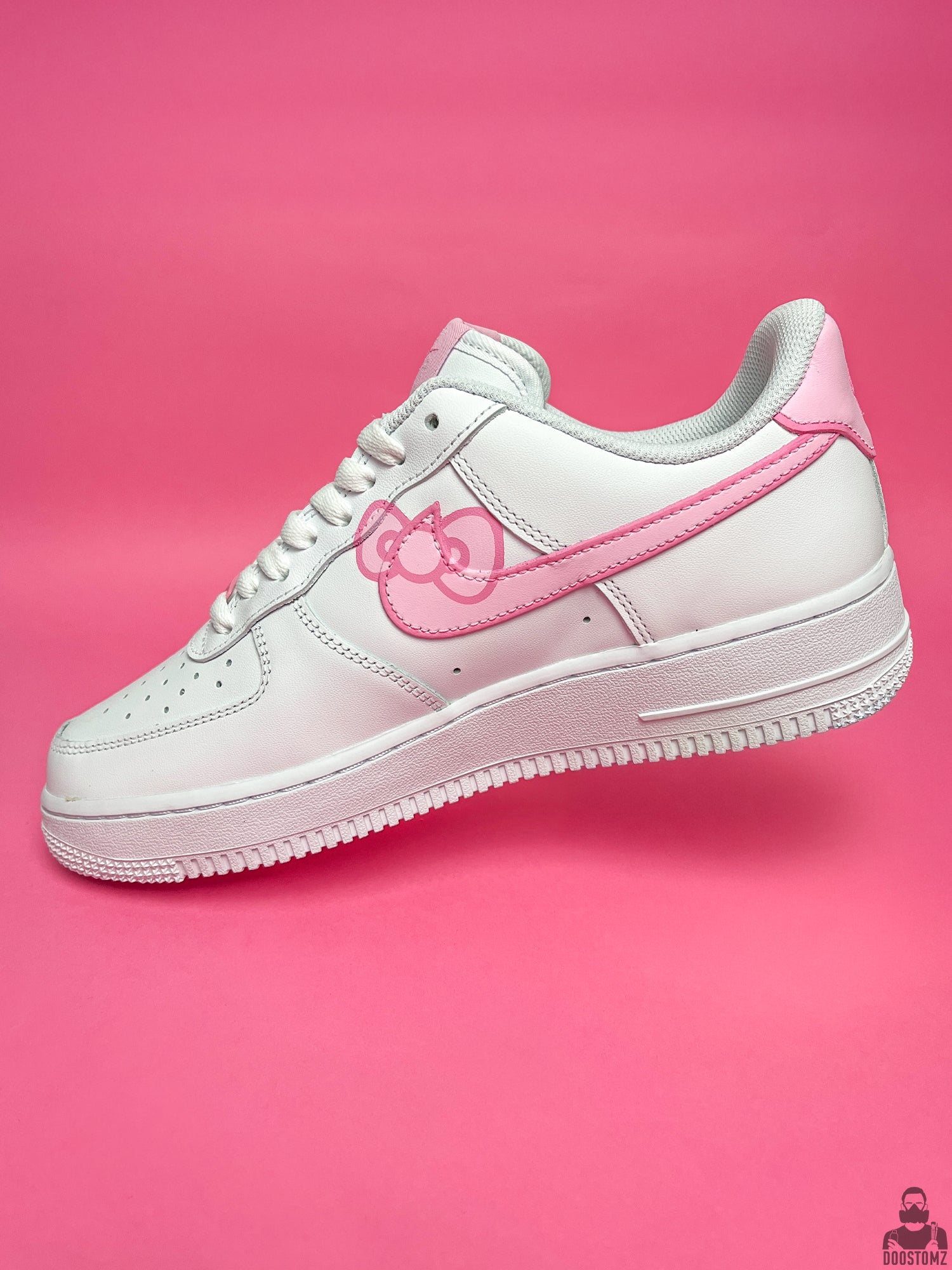 Nike Air Force 1 Hello Kitty Custom side profile featuring hand-painted pink artwork on a white sneaker