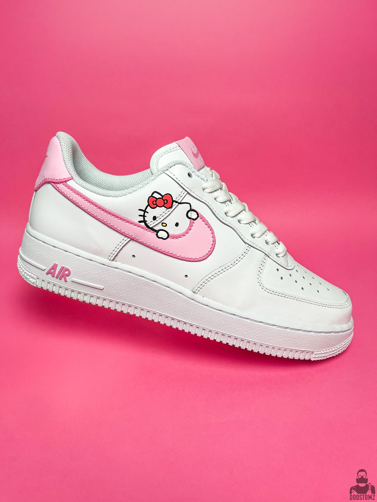 Side view of hand-painted Nike Air Force 1 Hello Kitty Custom sneakers with pink accents and character artwork