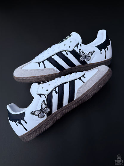 Custom Adidas Samba sneakers in a stacked diagonal arrangement with black drip details and butterfly artwork