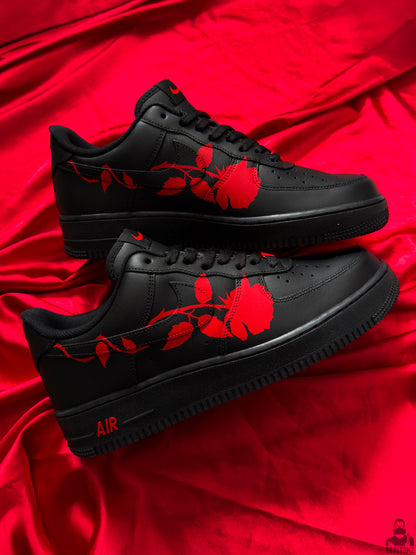 Pair of black Nike Air Force 1 custom shoes featuring red roses across both sides