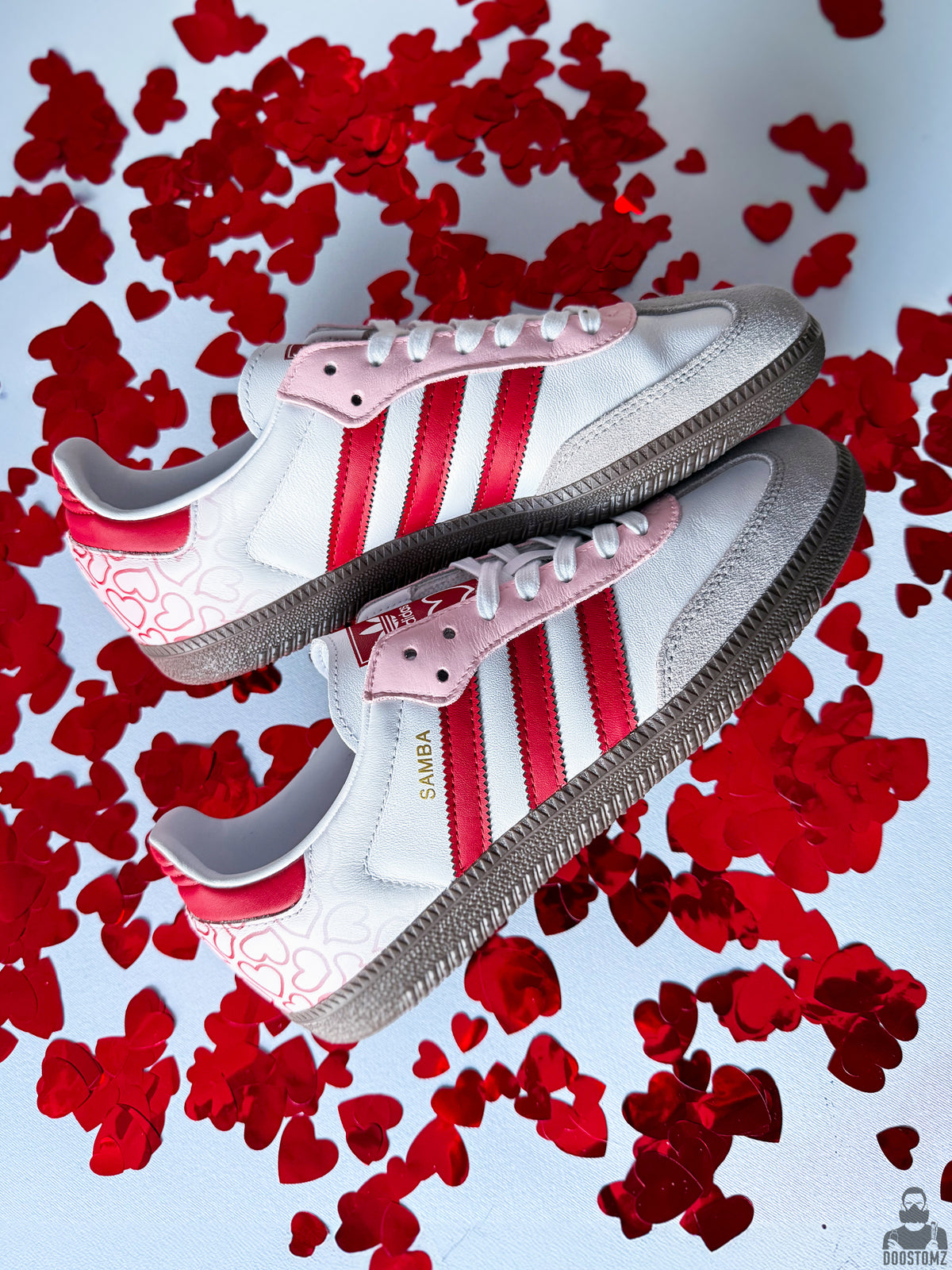 Hand holding a pair of Adidas Samba Love Custom sneakers