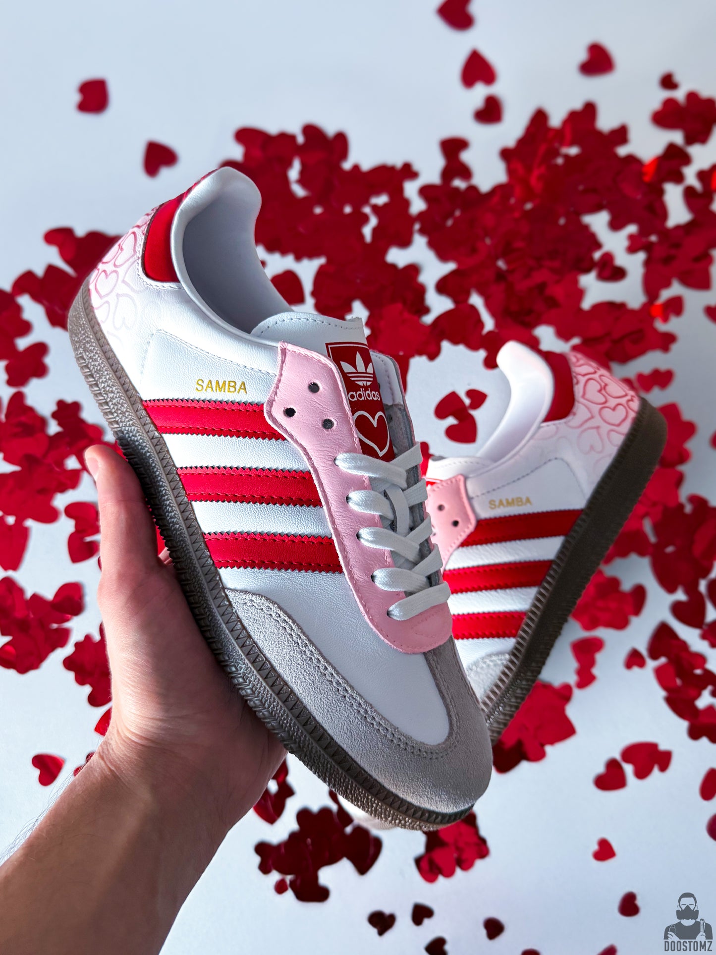 Top view of hand-painted Adidas Samba Custom sneakers with pink, red and white details